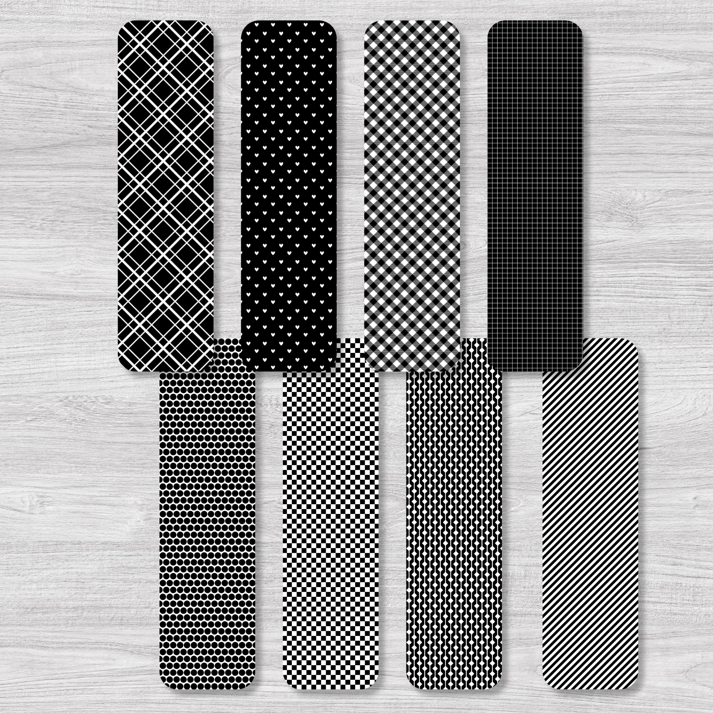 Set of black and white patterned bookmarks on a wooden surface