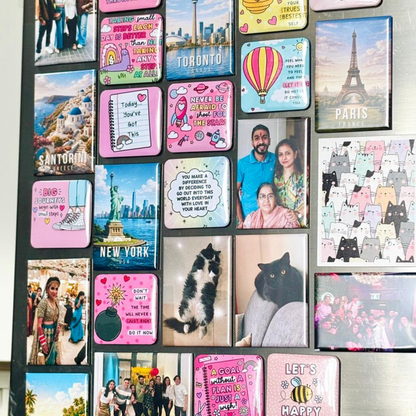 Collection of various magnets on a board with different designs and images.