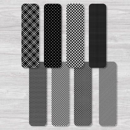 Set of black and white patterned bookmarks on a wooden surface